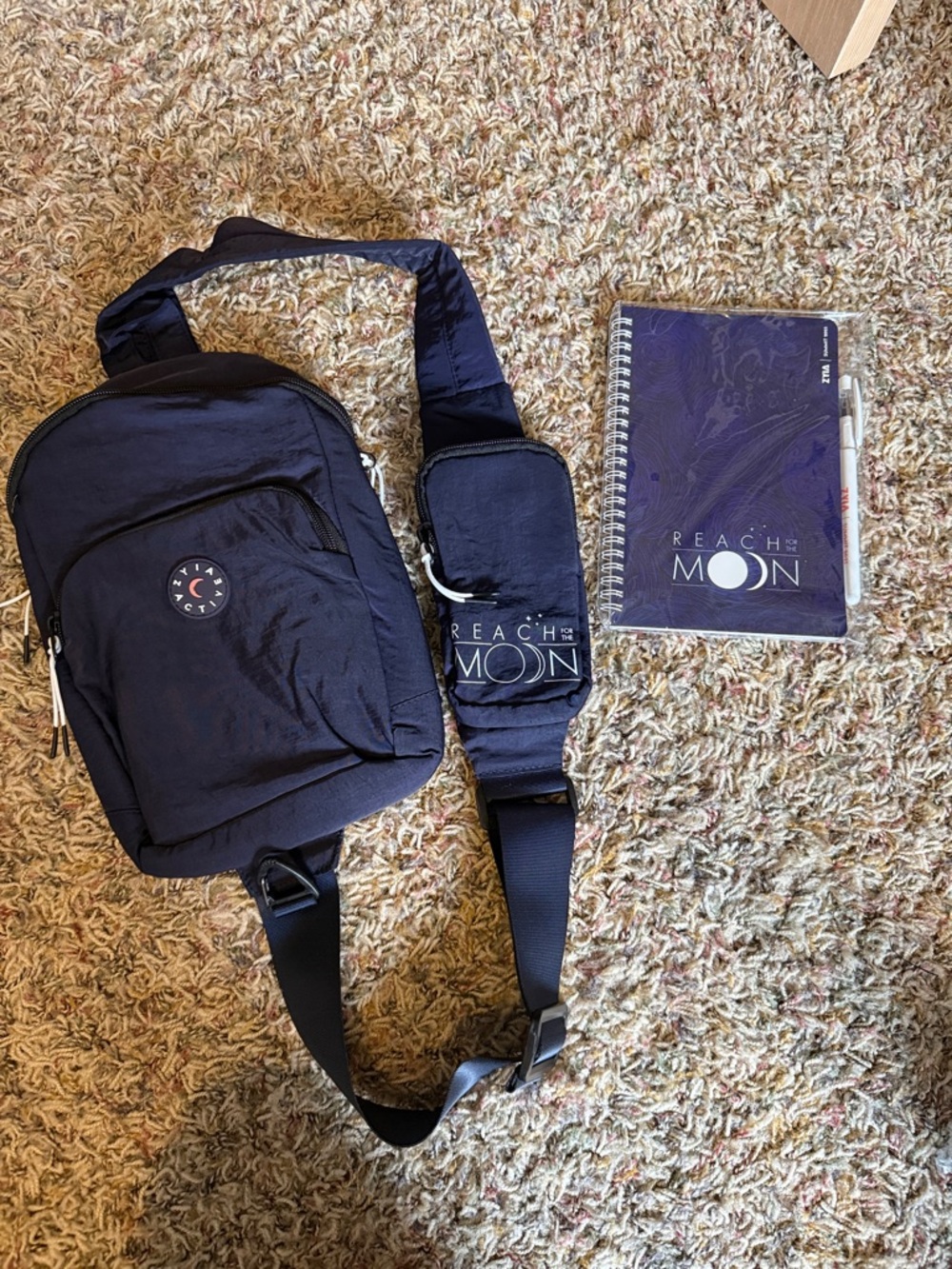 Navy Crossbody Bag and matching notebook with pen.